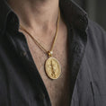 Load image into Gallery viewer, Gold plated Saint Michael spinning pendant necklace worn on the chest, premium lifestyle jewelry photo with the rotating Saint Michael medal centered on a spiga chain.