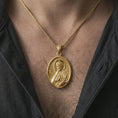 Load image into Gallery viewer, Gold plated Saint James the Apostle pendant necklace worn on the chest, premium lifestyle jewelry photo with the Saint James medal centered on a spiga chain.