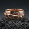 Load image into Gallery viewer, Rose gold plated Bushido sword band ring on textured volcanic rock, detailed macro product shot with soft warm reflections and Japanese warrior-inspired design.