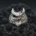 Load image into Gallery viewer, Polished sterling silver owl ring shot on textured volcanic rock in a centered macro composition with crisp detail.