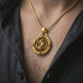 Load image into Gallery viewer, A gold plated dragon pendant is worn on the neck in a close-up lifestyle shot, styled as a fantasy-inspired protection amulet for men.