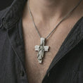Load image into Gallery viewer, Polished silver Jesus cross pendant necklace worn on the chest, masculine lifestyle shot highlighting the Christ relief, sacred heart rays, and bright silver finish.