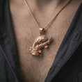 Load image into Gallery viewer, Rose gold plated chameleon pendant necklace worn on the chest, close-up lifestyle shot featuring the nature-inspired chameleon charm with warm rose gold tones.