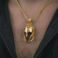 Load image into Gallery viewer, Gold plated Spartan helmet pendant necklace worn on the chest, premium lifestyle jewelry photo with the ancient warrior helmet pendant centered on a spiga chain.