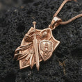 Load image into Gallery viewer, Rose gold plated medieval warrior pendant on volcanic stone, cinematic macro lighting highlighting the raised armor lines.