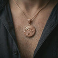 Load image into Gallery viewer, A rose gold plated Eye of Horus pendant is worn on the neck in a close-up lifestyle composition, highlighting its Egyptian-inspired symbolic detail.