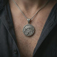 Load image into Gallery viewer, An oxidized Eye of Horus pendant is worn on the neck in a close-up lifestyle shot, centered on the chest as a bold Egyptian symbol necklace.