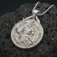 Load image into Gallery viewer, A polished silver Spartan warrior pendant is displayed on black volcanic rock in a premium macro studio close-up with sharp ancient soldier details.