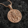 Load image into Gallery viewer, Rose gold plated Masonic double headed eagle pendant necklace on textured volcanic rock, detailed macro product shot with soft warm reflections and symbolic Scottish Rite eagle relief.