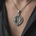 Load image into Gallery viewer, Oxidized Pisces zodiac pendant necklace worn on the chest, close-up lifestyle jewelry photo showing the astrology medallion on a spiga chain with dark clothing.