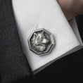 Load image into Gallery viewer, An oxidized wolf head cufflink is worn on a white shirt cuff in a close-up lifestyle shot, styled with a dark suit for a bold formal look.