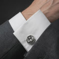 Load image into Gallery viewer, An oxidized scarab cufflink is worn on a white shirt cuff in a close-up lifestyle shot, styled with a dark suit as a symbolic Egyptian accessory.