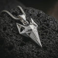 Load image into Gallery viewer, A polished silver Freyja cat pendant is displayed on black volcanic rock in a premium macro studio close-up with sharp geometric lines and bold feline detail.