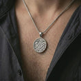 Load image into Gallery viewer, Polished silver Masonic pendant necklace worn on the chest, masculine lifestyle shot highlighting the bright silver finish, ornate scroll details, and central G emblem.