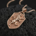 Load image into Gallery viewer, Rose gold plated heraldic lion shield pendant necklace on textured volcanic rock, detailed macro product shot with soft warm reflections and symbolic lion crest styling.