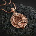 Load image into Gallery viewer, Rose gold plated Scorpio zodiac pendant necklace on textured volcanic rock, detailed macro product shot with soft warm reflections and symbolic zodiac styling.