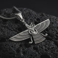 Load image into Gallery viewer, Oxidized Faravahar pendant necklace on textured volcanic rock, close-up studio shot highlighting the winged guardian figure, Zoroastrian symbol, feather details, and antique silver contrast.
