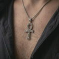 Load image into Gallery viewer, Oxidized ankh cross pendant necklace worn on the chest, close-up lifestyle jewelry photo showing the ancient Egyptian amulet on a spiga chain with dark clothing.