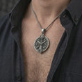 Load image into Gallery viewer, Oxidized Libra zodiac pendant necklace worn on the chest, close-up lifestyle jewelry photo showing the astrology medallion on a spiga chain with dark clothing.