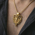 Load image into Gallery viewer, Gold plated biomechanical ram skull pendant necklace worn on the chest, premium lifestyle jewelry photo with the mechanical ram skull pendant centered on a spiga chain.