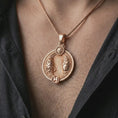 Load image into Gallery viewer, Rose gold plated Pisces zodiac pendant necklace worn on the chest, close-up lifestyle shot featuring the flowing Pisces zodiac design with warm rose gold tones.