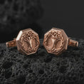 Load image into Gallery viewer, Rose gold plated Yggdrasil cufflinks are photographed on porous volcanic rock in a close-up studio composition with refined luxury lighting and symbolic branch detail.