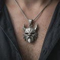 Load image into Gallery viewer, An oxidized Surtur pendant is worn on the neck in a close-up lifestyle shot, centered on the chest as a bold Norse mythology statement piece.