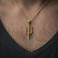 Load image into Gallery viewer, Gold plated Poseidon trident pendant necklace worn on the chest, premium lifestyle jewelry photo with the sea god trident pendant centered on a spiga chain.