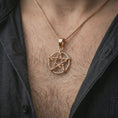 Load image into Gallery viewer, Rose gold plated thorn pentagram pendant necklace worn on the chest, close-up lifestyle shot featuring the thorn star design with warm rose gold tones.