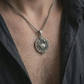 Load image into Gallery viewer, Oxidized Cancer zodiac pendant necklace worn on the chest, close-up lifestyle jewelry photo showing the crab astrology medallion on a spiga chain with dark clothing.