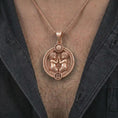 Load image into Gallery viewer, Rose gold plated Gemini zodiac pendant necklace worn on the chest, close-up lifestyle shot featuring the expressive Gemini zodiac design with warm rose gold tones.