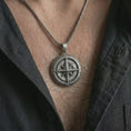 Load image into Gallery viewer, Oxidized compass pendant necklace worn on the chest, close-up lifestyle jewelry photo showing the nautical navigation medallion on a spiga chain with dark clothing.
