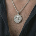 Load image into Gallery viewer, Polished silver Baphomet pendant necklace worn on the chest, gothic lifestyle shot highlighting the bright silver finish, horned goat relief, and engraved sigil details.