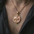 Load image into Gallery viewer, Rose gold plated Taurus zodiac pendant necklace worn on the chest, close-up lifestyle shot featuring the strong Taurus zodiac design with warm rose gold tones.