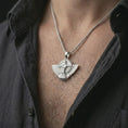 Load image into Gallery viewer, A polished silver Faravahar pendant is worn on the neck in a premium close-up lifestyle image, showing the winged symbol and central figure clearly.