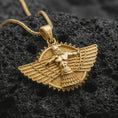 Load image into Gallery viewer, A gold plated Faravahar pendant lies on textured volcanic rock in a dramatic studio macro shot, highlighting the Zoroastrian winged symbol design.