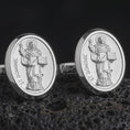 Load image into Gallery viewer, Polished silver St Dominic cufflinks are displayed on black volcanic rock in a premium macro studio close-up with detailed Christian devotional artwork.