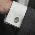 Load image into Gallery viewer, An oxidized Pensive Christ cufflink is worn on a white shirt cuff in a close-up lifestyle shot, styled with a dark suit as a meaningful Christian accessory.