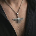 Load image into Gallery viewer, Oxidized Faravahar pendant necklace worn on the chest, close-up lifestyle jewelry photo showing the Persian guardian angel symbol on a spiga chain with dark clothing.