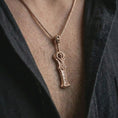 Load image into Gallery viewer, A rose gold plated demon slayer sword pendant is worn on the neck in a close-up lifestyle composition, highlighting its hell blade form and warrior amulet character.