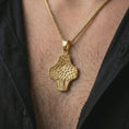 Load image into Gallery viewer, A gold plated Tree of Life cross pendant is worn on the neck in a close-up lifestyle shot, styled as a symbolic spiritual gift for men and women.