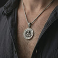 Load image into Gallery viewer, Oxidized Spartan warrior pendant necklace worn on the chest, close-up lifestyle jewelry photo showing the strength family courage medallion on a spiga chain with dark clothing.
