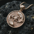 Load image into Gallery viewer, Rose gold plated koi fish lotus pendant necklace on textured volcanic rock, detailed macro product shot with soft warm reflections and symbolic koi fish styling.