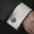 Load image into Gallery viewer, An oxidized Zeus cufflink is worn on a white shirt cuff in a close-up lifestyle shot, styled with a dark suit for a powerful formal look.