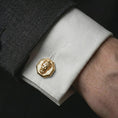 Load image into Gallery viewer, A gold plated Zeus cufflink is worn on a white cuff in a close-up lifestyle shot, styled as a meaningful mythology gift for men.