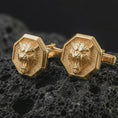 Load image into Gallery viewer, Gold plated tiger head cufflinks sit on textured volcanic rock in a dramatic studio macro shot, highlighting the powerful animal motif and formal accessory design.