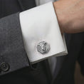 Load image into Gallery viewer, A polished silver bull head cufflink is worn on a shirt cuff in a premium close-up lifestyle image, showing the sculpted horned bull face clearly.