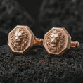 Load image into Gallery viewer, Rose gold plated lion head cufflinks are photographed on porous volcanic rock in a close-up studio composition with refined luxury lighting and detailed lion features.
