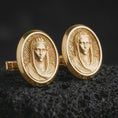 Load image into Gallery viewer, Gold plated Virgin Mary cufflinks sit on textured volcanic rock in a dramatic studio macro shot, highlighting the sacred Marian portrait design.