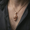 Load image into Gallery viewer, A rose gold plated gorilla pendant is worn on the neck in a close-up lifestyle composition, highlighting its fierce gorilla head and rugged animal symbolism.